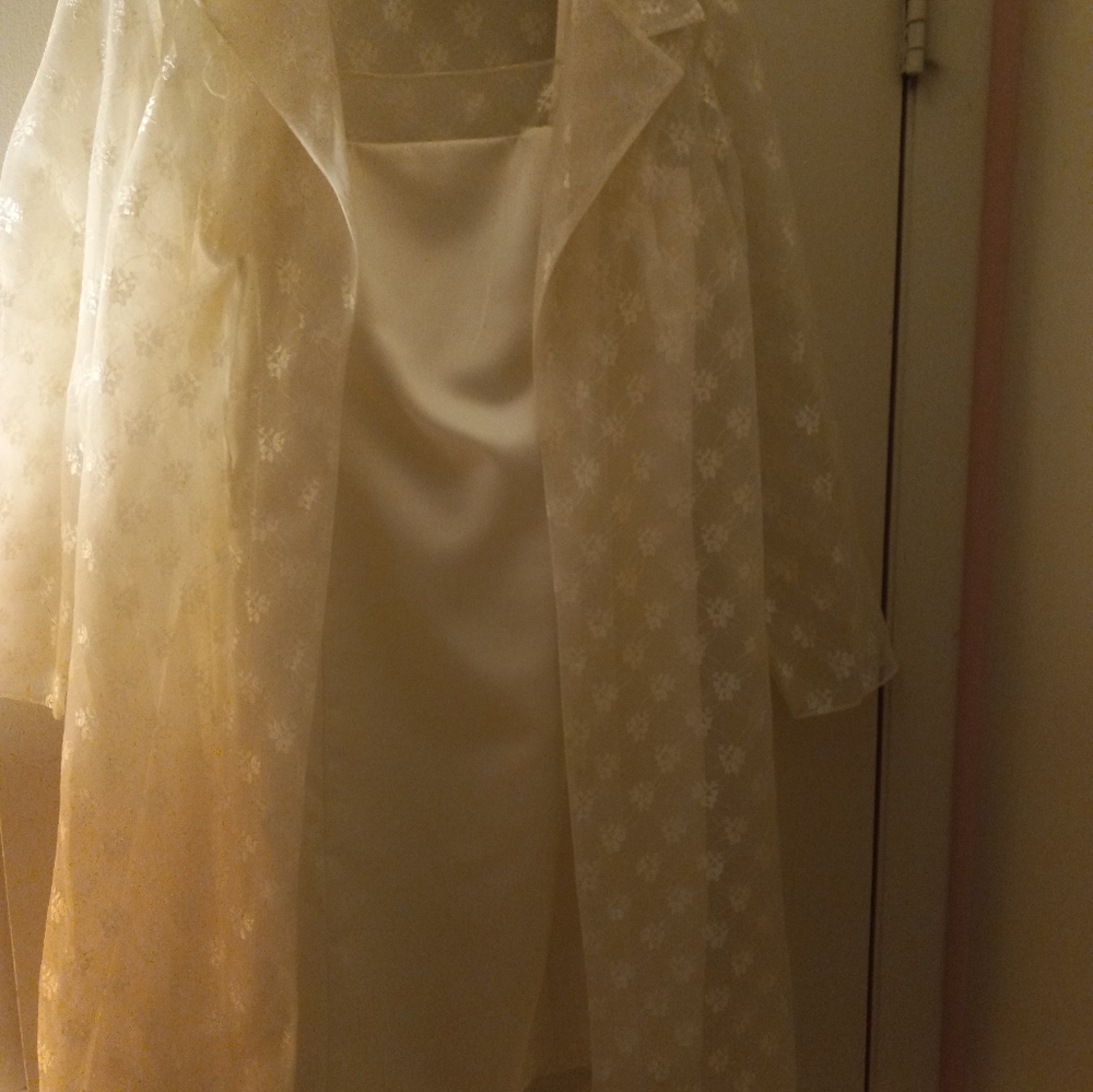 A new, never worn after five cream colored dress, with a shear coat over it.
